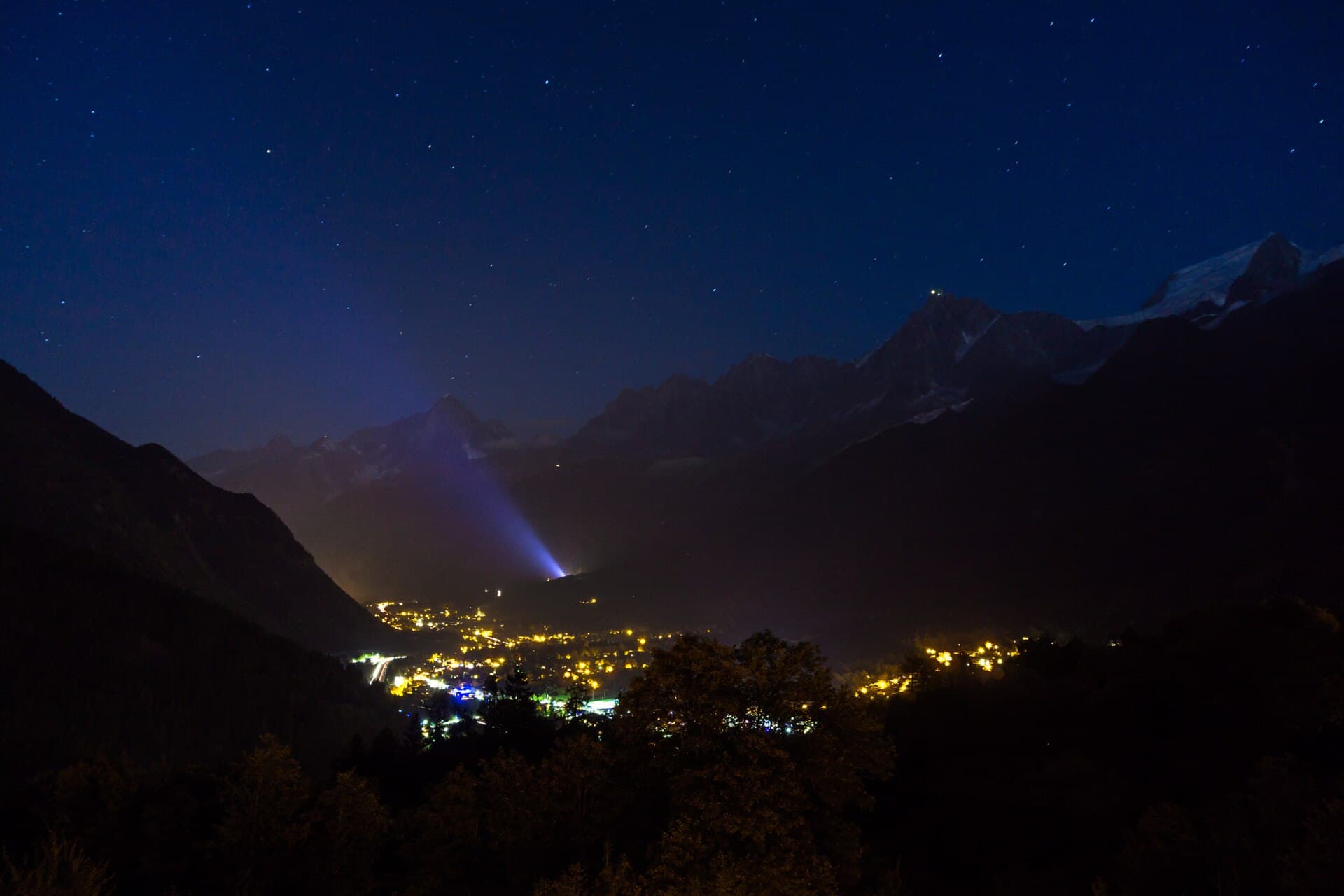 The lights of Chamonix glow beneath a dark, starry mountain skyline at night in 2016.