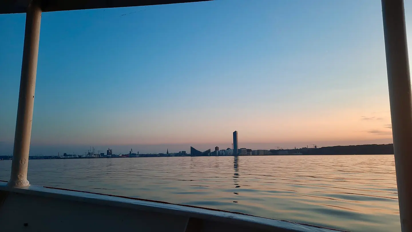Lighthouse and Aarhus Ø Docklands seen from boat June sunset Denmark 02