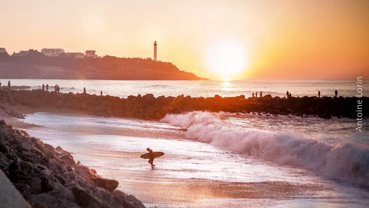 500px provided description: Surfer getting out of the water, after a cold day riding