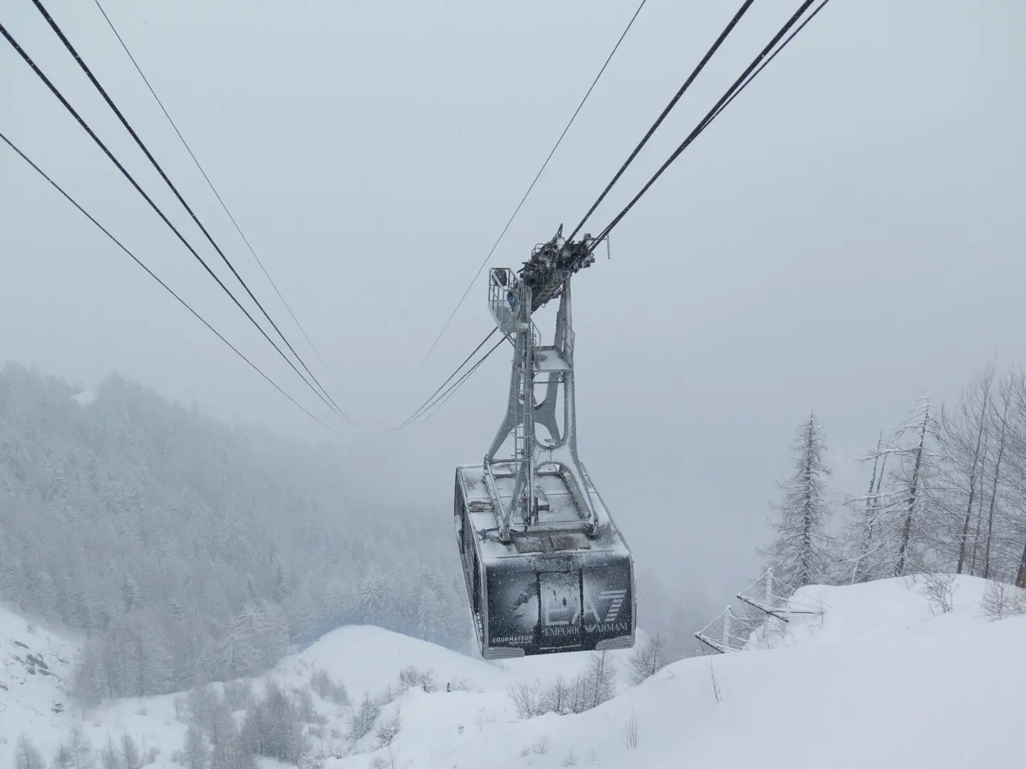 500px provided description: The cable car coming out of the mists to take us off the mountain at the Courmayeur ski resort in Italy