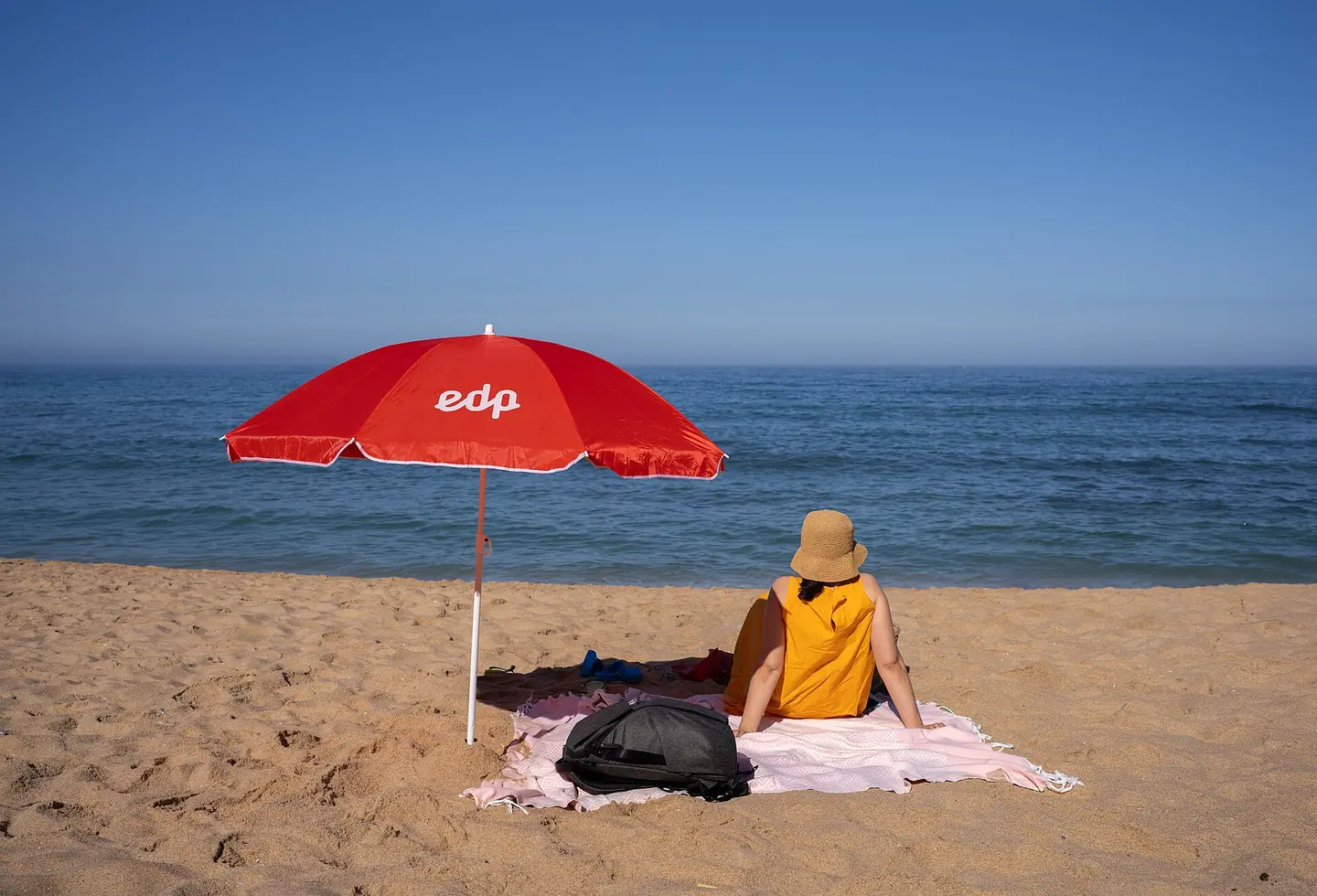 Jules next to a beach umbrella, Praia da Baleia, Ericeira, Portugal