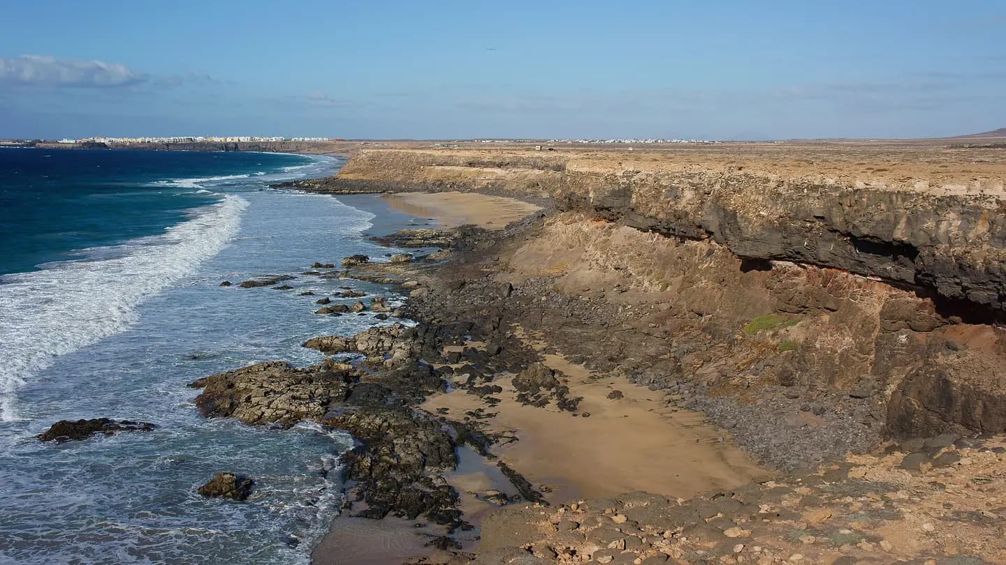 Western coast of Fuerteventura near Punta Mallorquin with El Cotillo in the distance
