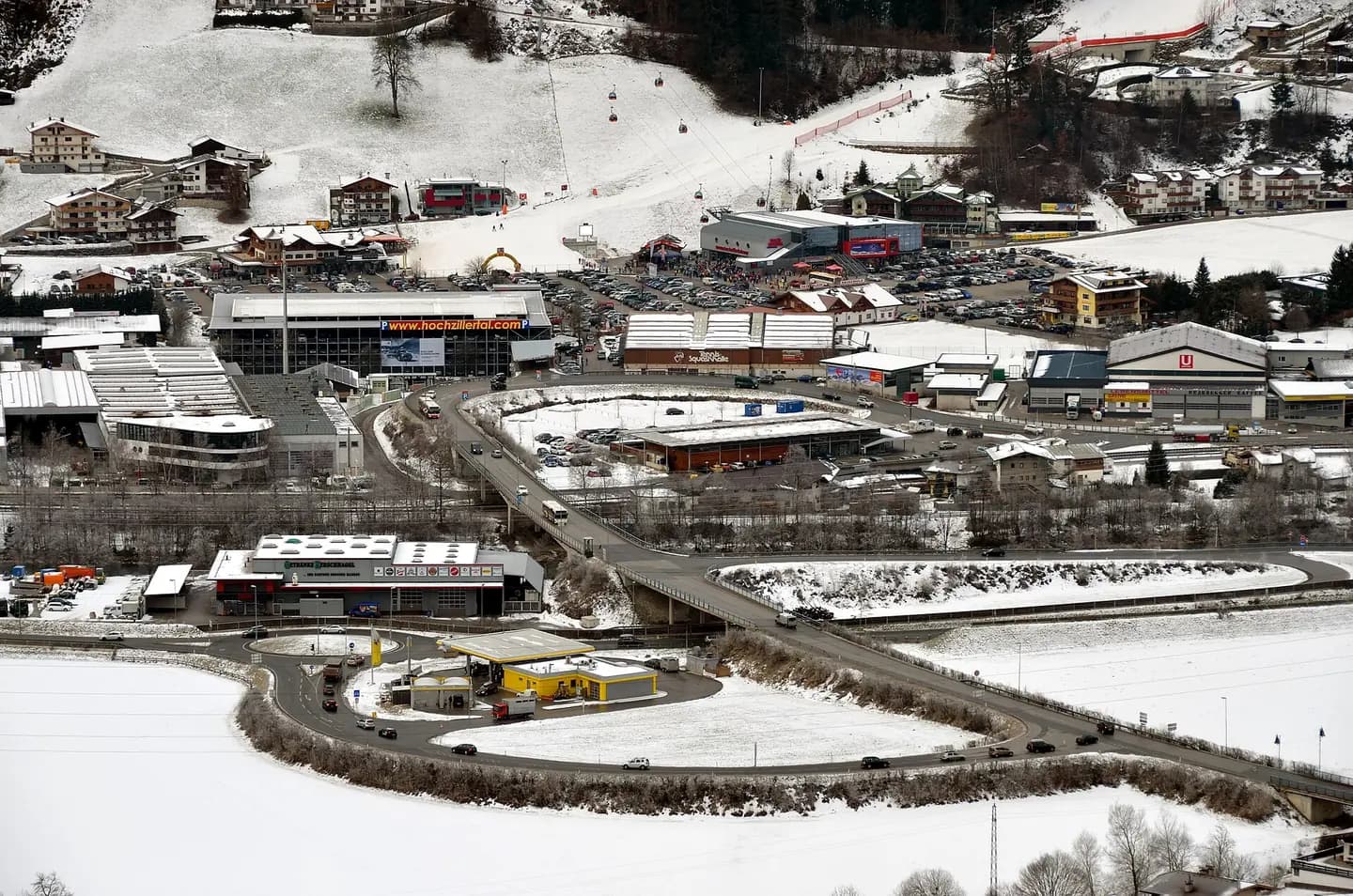Ski resort Kaltenbach, Zillertal, Tyrol. Start of the cable car up to the skiing area with the Zillertal Straße (the main road), road access, parking lots and a multi-storey car park