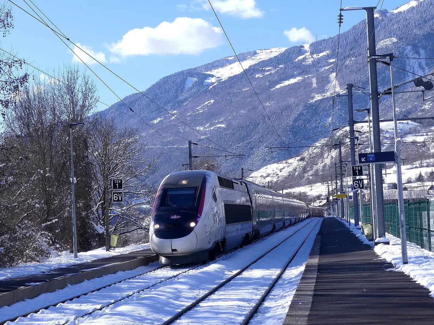 Sight of French TGVs on winter journeys n° 6429 and 32909 from Paris to Bourg-Saint-Maurice in Tarentaise valley, stopping at Aime-la-Plagne station near its terminus, in Savoie , France