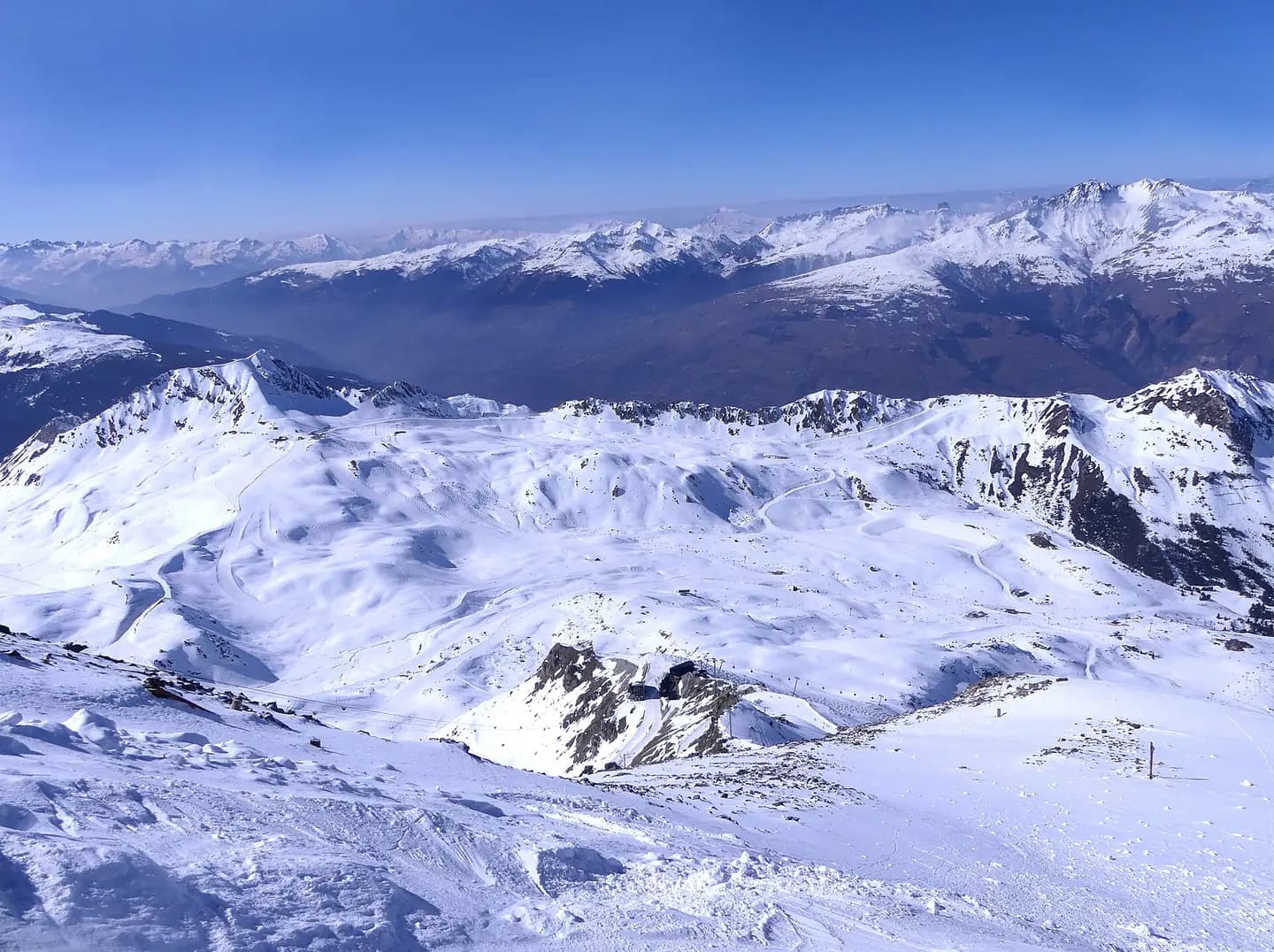 Sight, in winter from Aiguille Rouge mountain, of Les Arcs ski resort area and Tarentaise valley at the background, in Savoie , France