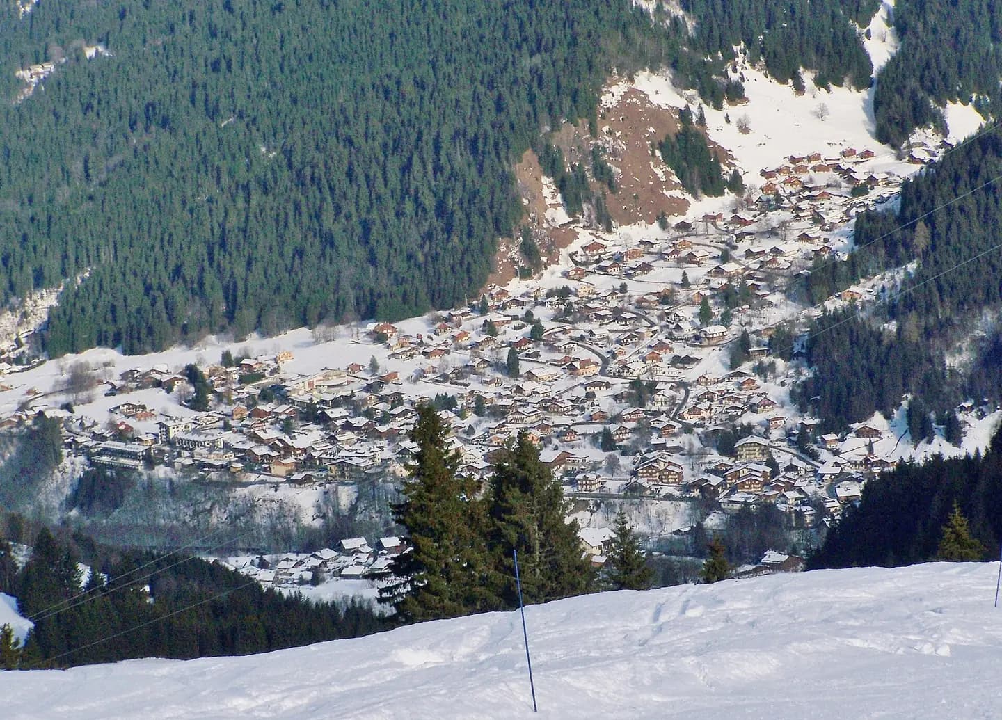 Sight of French village Les Contamines-Montjoie seen from the heights of the ski resort, in Haute-Savoie