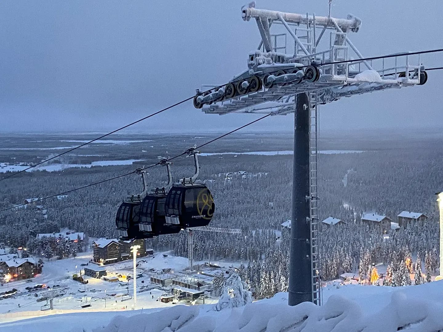 View of gondola from Levi fell ski resort in Lapland, Finland. Part of the town of Sirkka is visible in the bottom left
