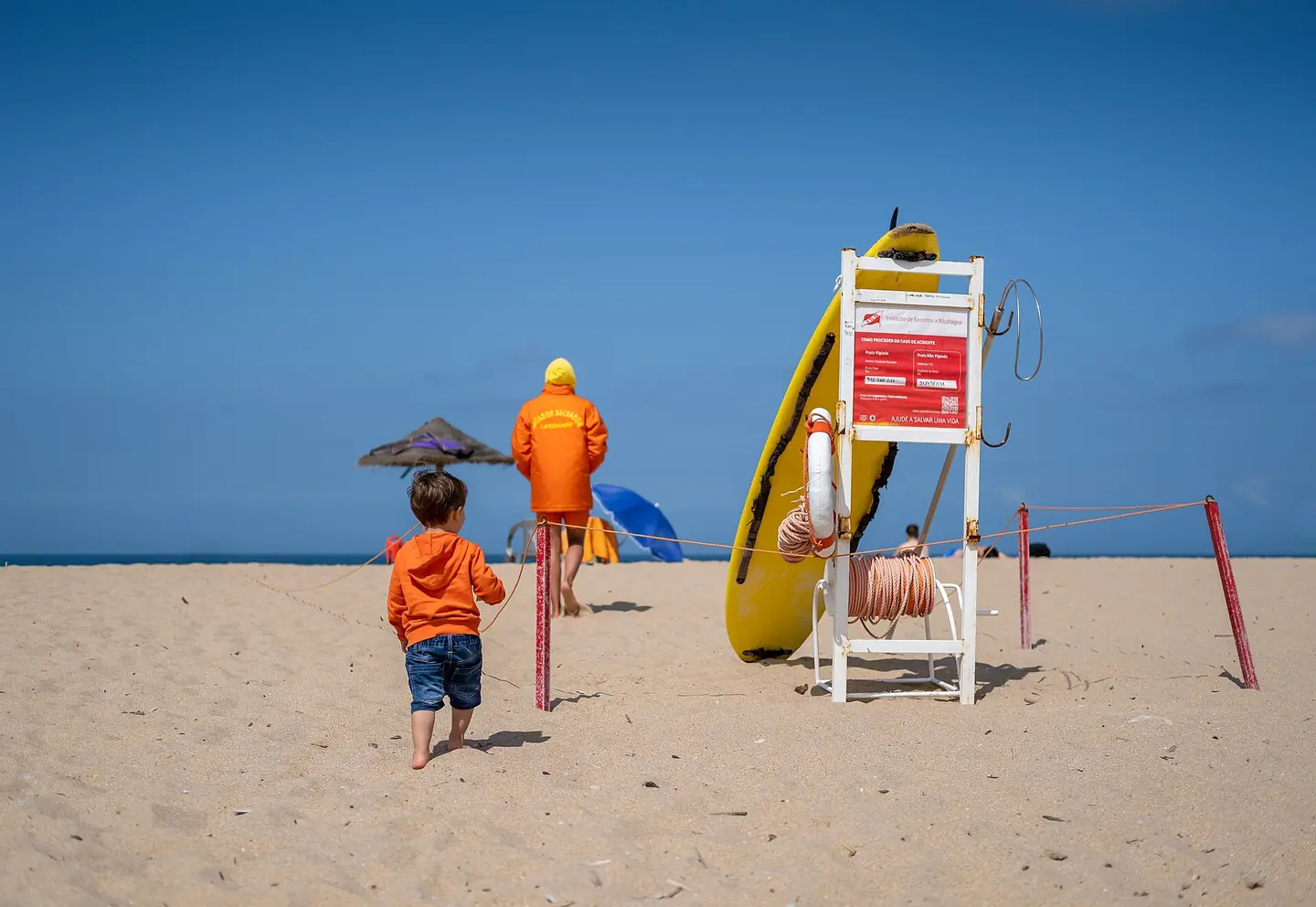 Gabriel and a lifeguard at Ribeira d'Ilhas beach, Ericeira, Portugal (PPL3-Altered)