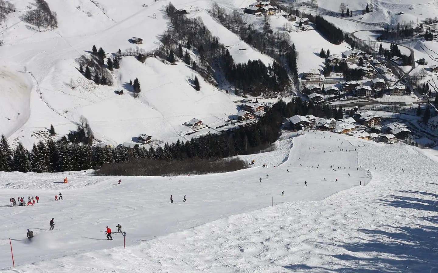The last part of the Jausernabfahrt slope with Vorderglemm village in the background, Saalbach-Hinterglemm, Austria