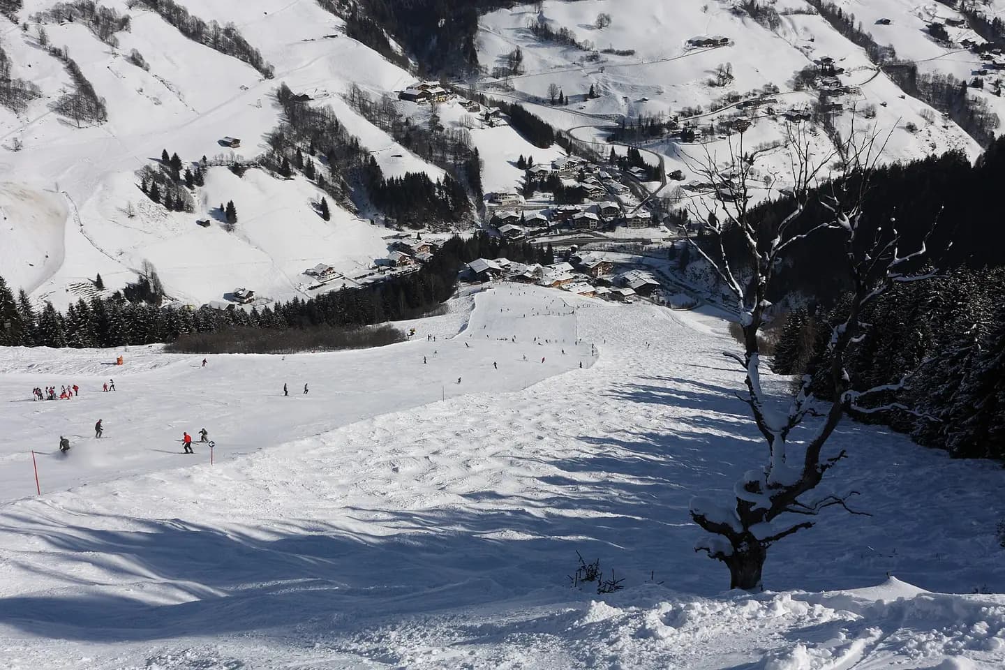The last part of the Jausernabfahrt slope with Vorderglemm village in the background, Saalbach-Hinterglemm, Austria