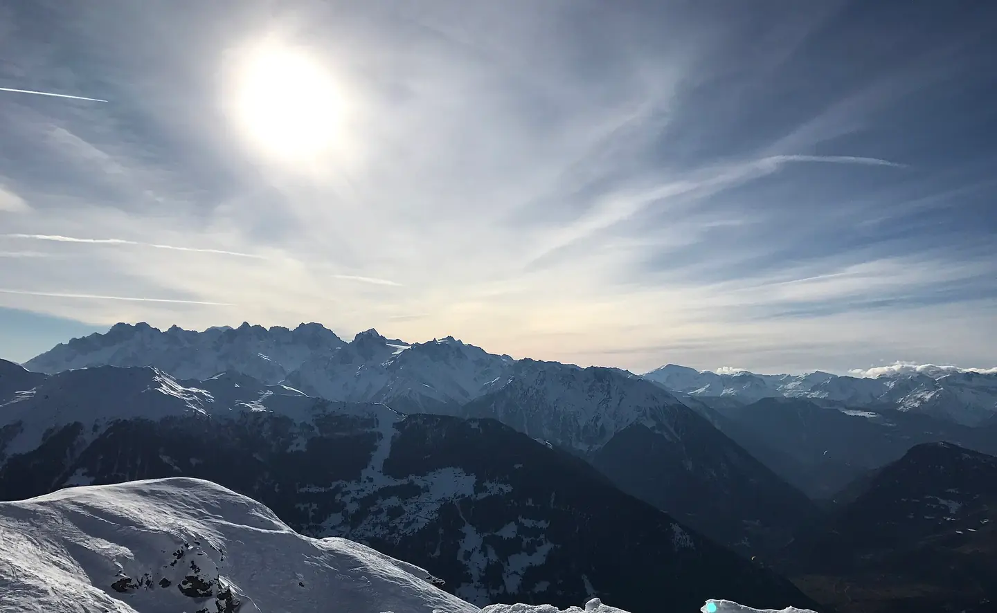 Looking West on the ski slopes into the Verbier valley during winter, with the mountains all around