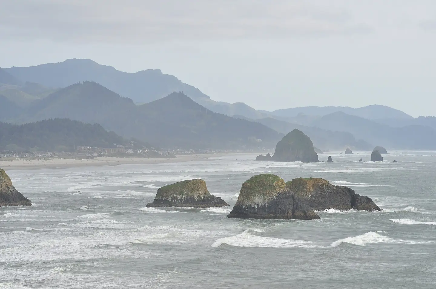 Cannon Beach, Oregon, U.S. Haystack Rock and other offshore rock formations seen from Ecola Point, Ecola State Park