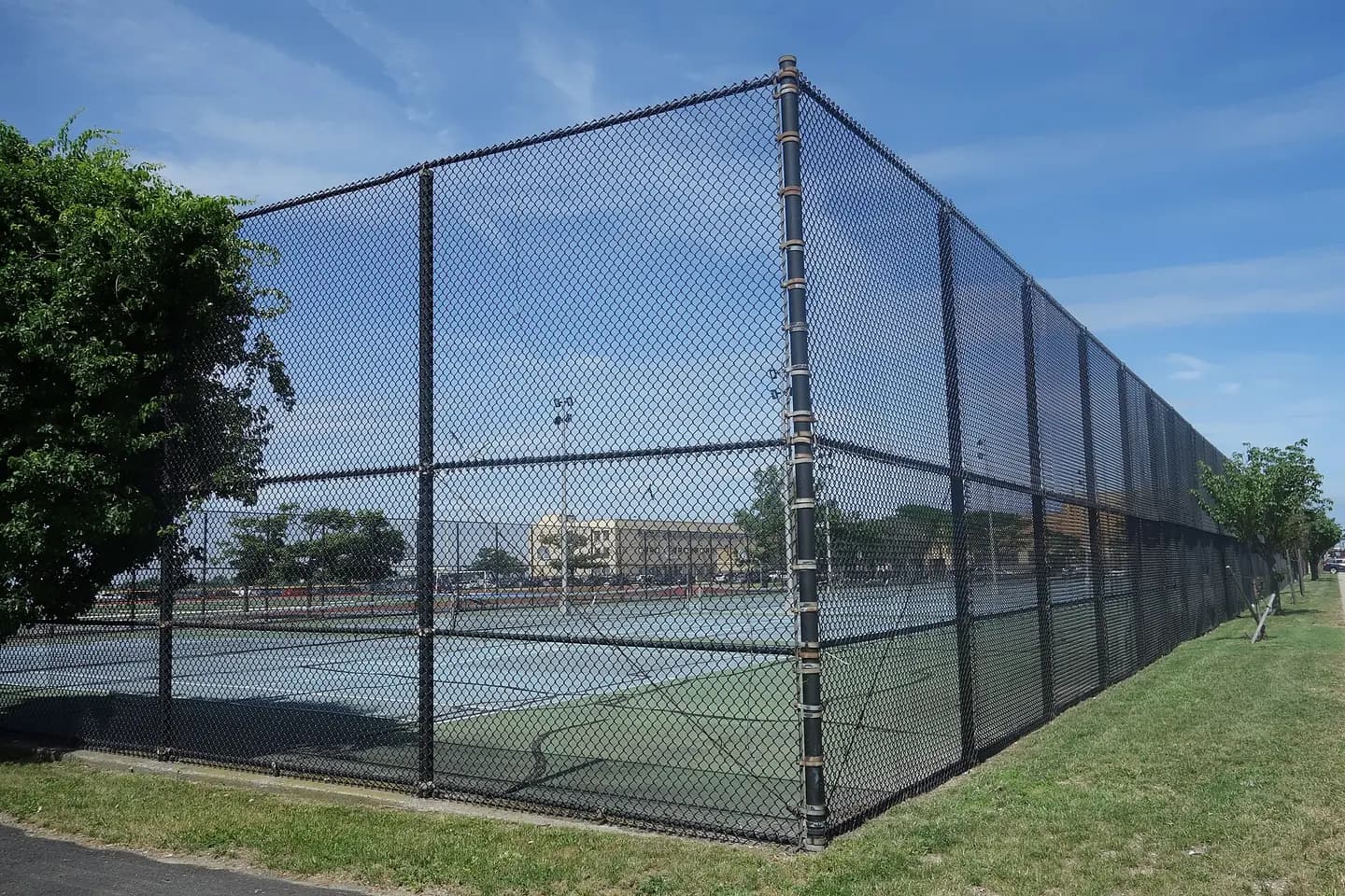 The athletic complex of Beach Channel High School, on the north side of Beach Channel Drive at Beach 104th Street in Seaside / Rockaway Beach, Queens. Pictured are the tennis courts, the eight tennis courts