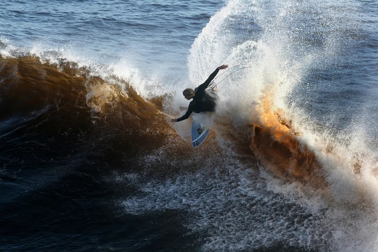 A California surfer. Santa Cruz and the surrounding Northern California coastline is a popular surfing destination; however, the year-round low temperature of the ocean in that region (averaging 57ºF/14ºC) necessitates the use of wetsuits