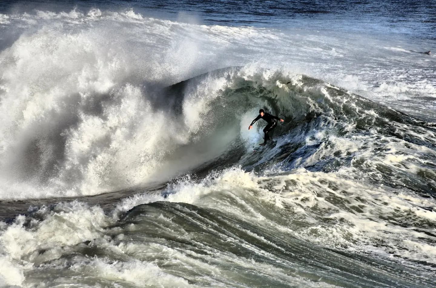 A California surfer. Santa Cruz and the surrounding Northern California coastline is a popular surfing destination; however, the year-round low temperature of the ocean in that region (averaging 57ºF/14ºC) necessitates the use of wetsuits
