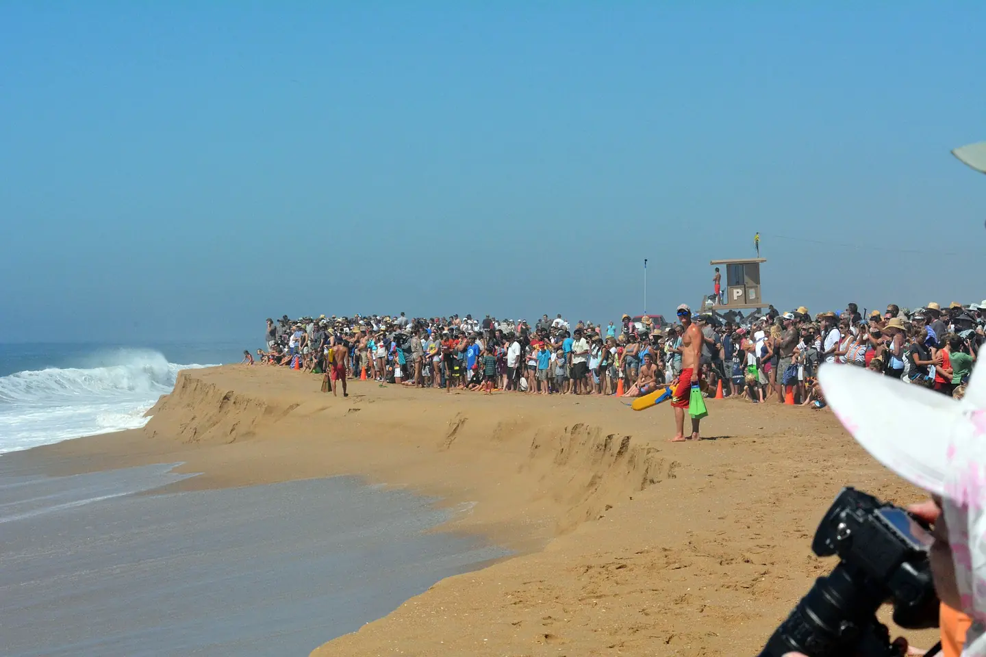 Crowds gather to watch giant waves at the Wedge Newport Beach