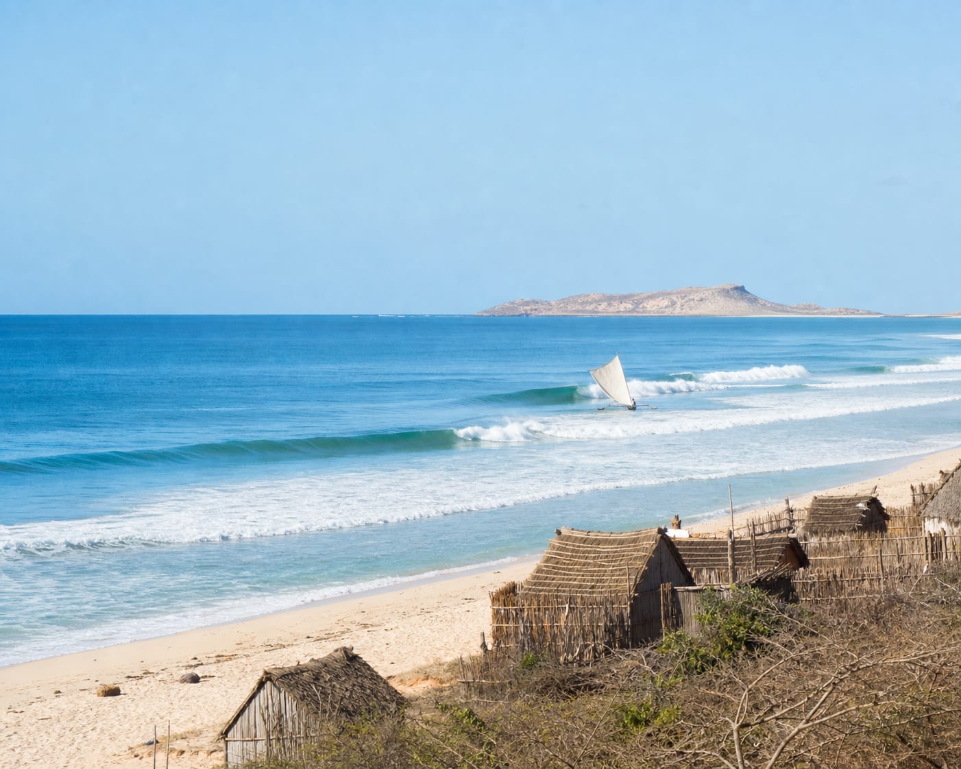 Anakao reef surf, Vezo sailing pirogue and fishing huts in southern Madagascar