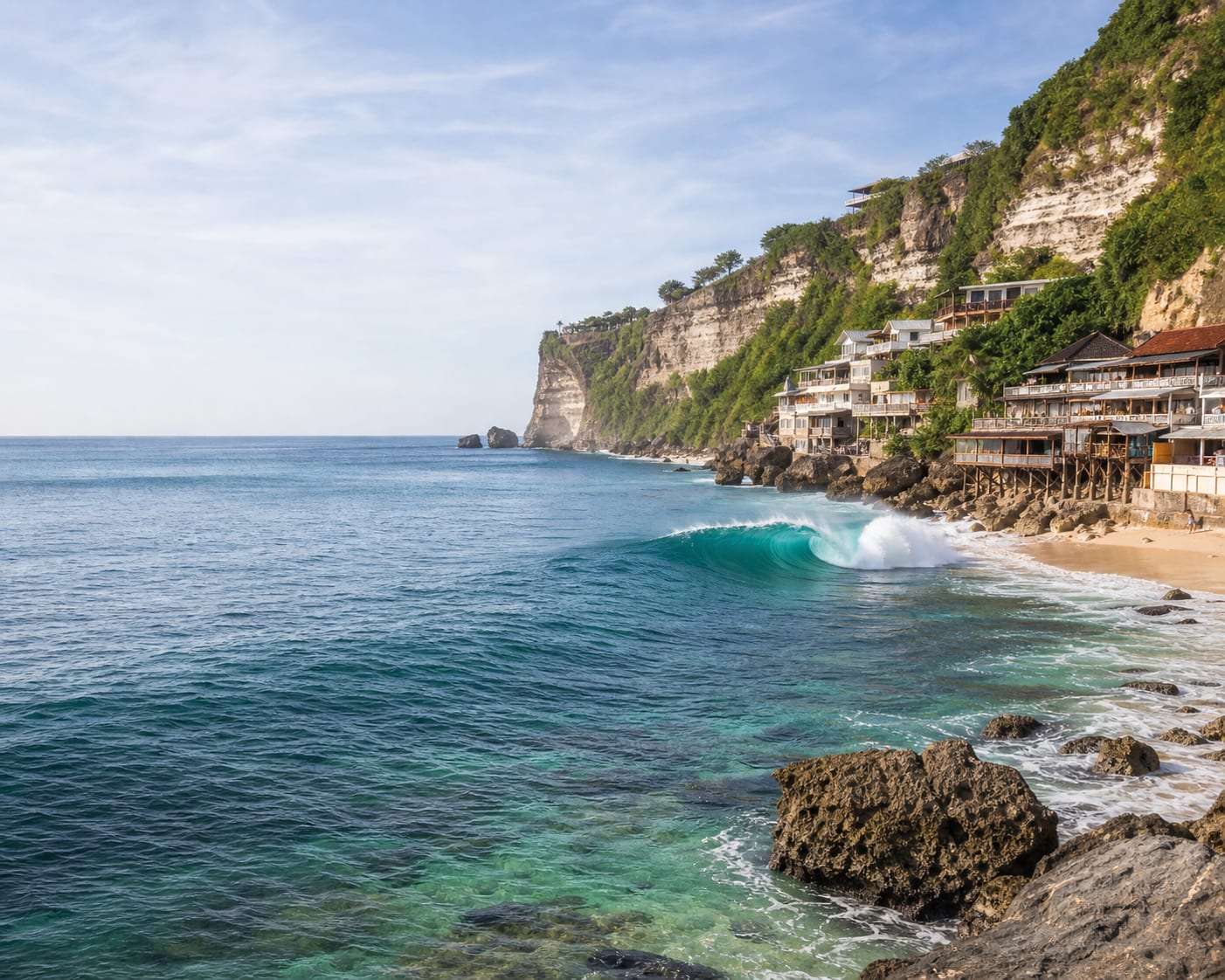 Bingin's hollow reef surf below limestone cliffs and timber warungs