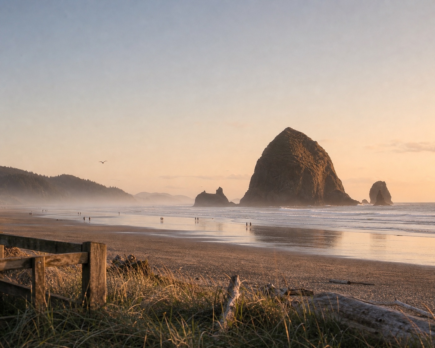 Haystack Rock and its sea stacks reflected on Cannon Beach at low tide
