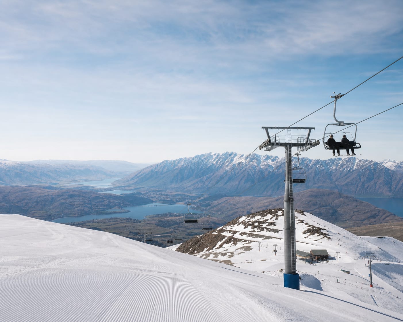 Coronet Peak chairlift above the Wakatipu Basin and the Remarkables
