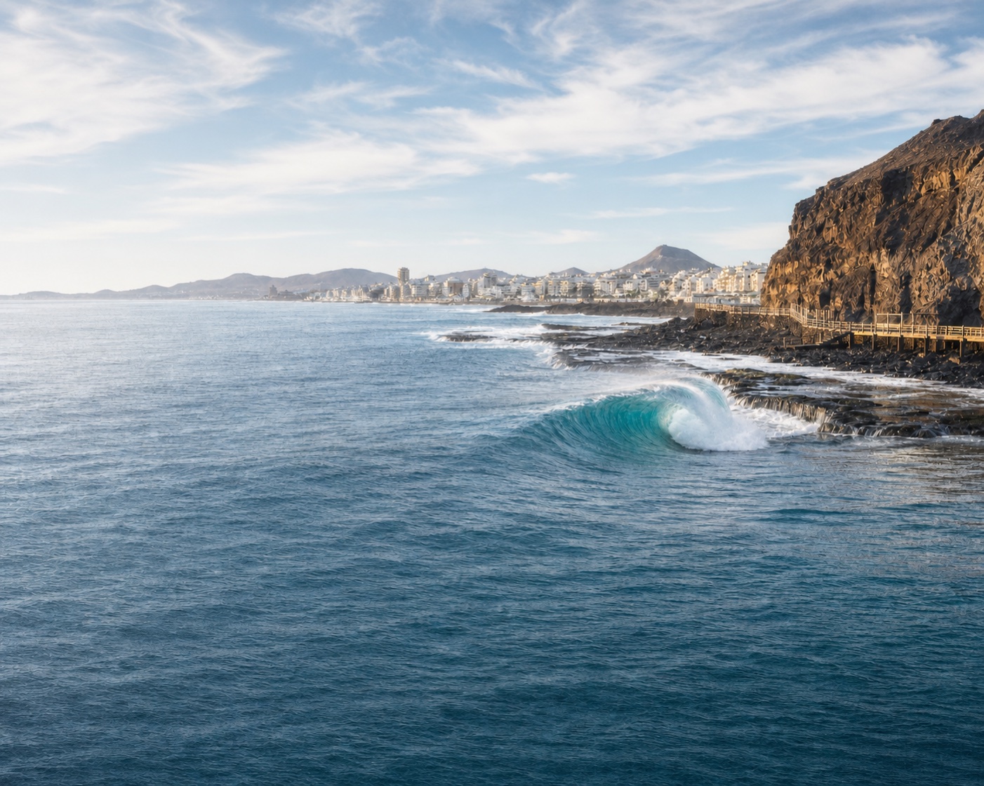 El Confital surf beneath La Isleta's volcanic cliffs