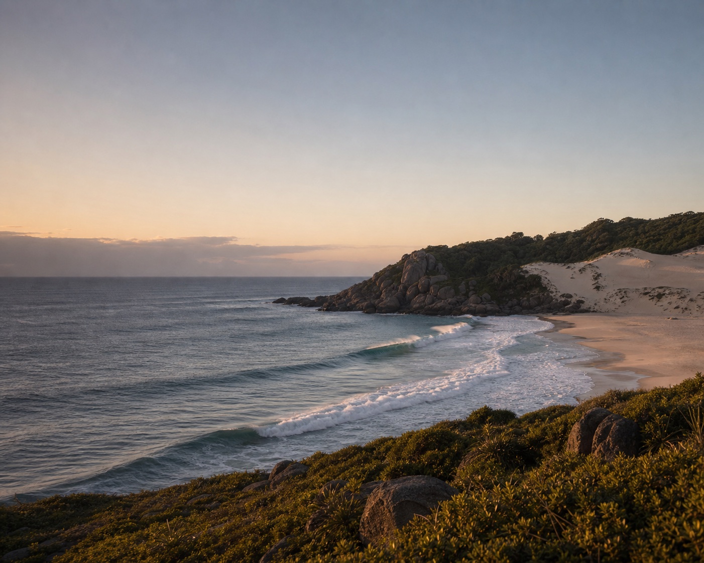 Joaquina surf beneath Florianópolis's pale dunes and granite headland