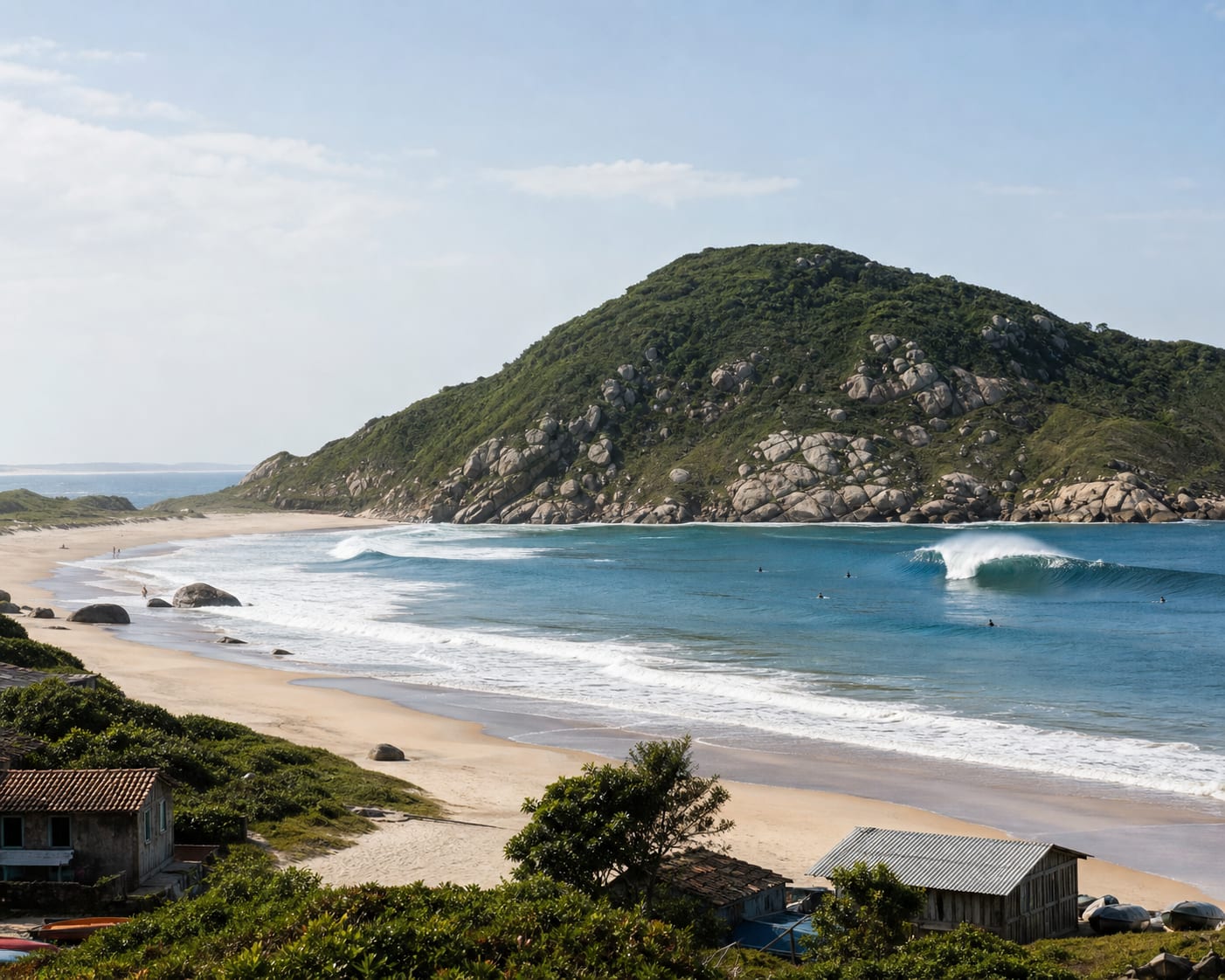 Garopaba surf beneath Praia da Silveira's green granite headland