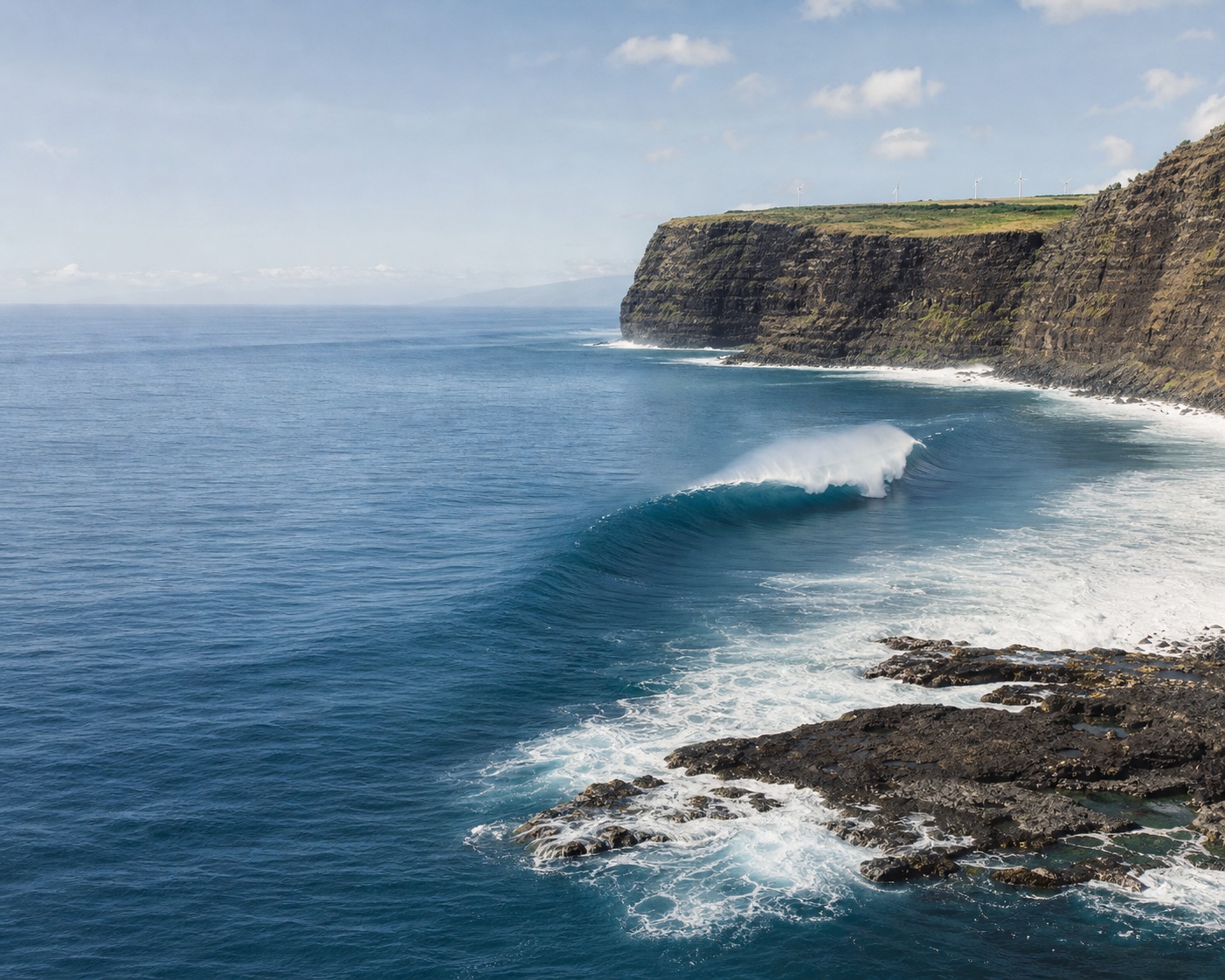 Peahi's immense Jaws wave breaking beneath remote north Maui cliffs
