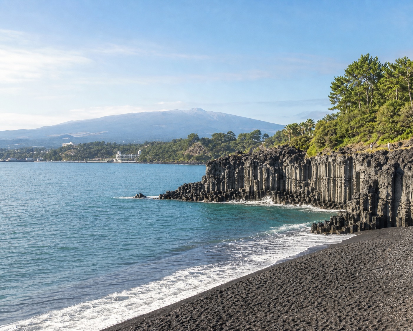 Jungmun surf beside Jeju's black sand and hexagonal basalt cliffs