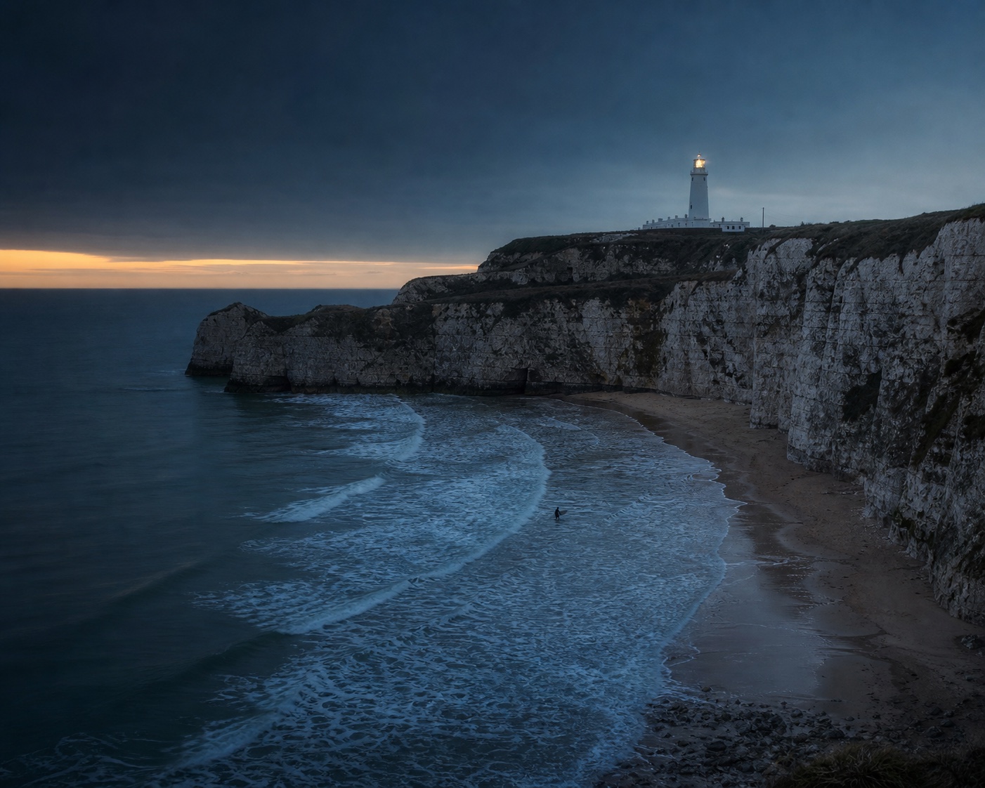 Joss Bay surf beneath chalk cliffs and North Foreland lighthouse