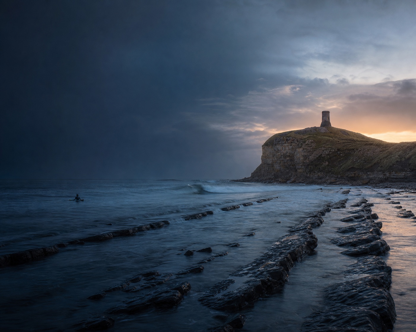 Kimmeridge Bay's limestone ledges beneath the circular Clavell Tower