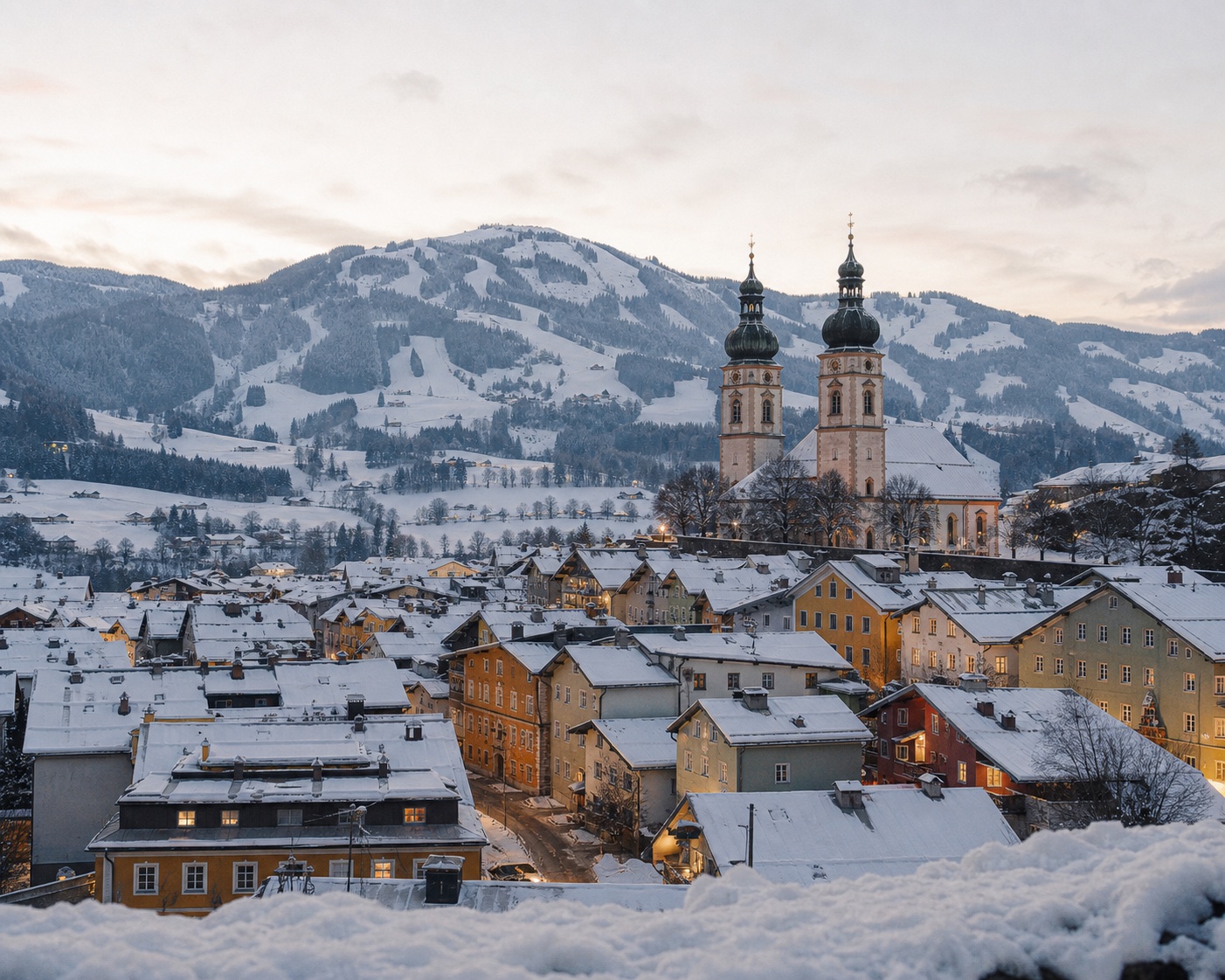 Kitzbühel's colourful old town and twin church towers beneath the Hahnenkamm