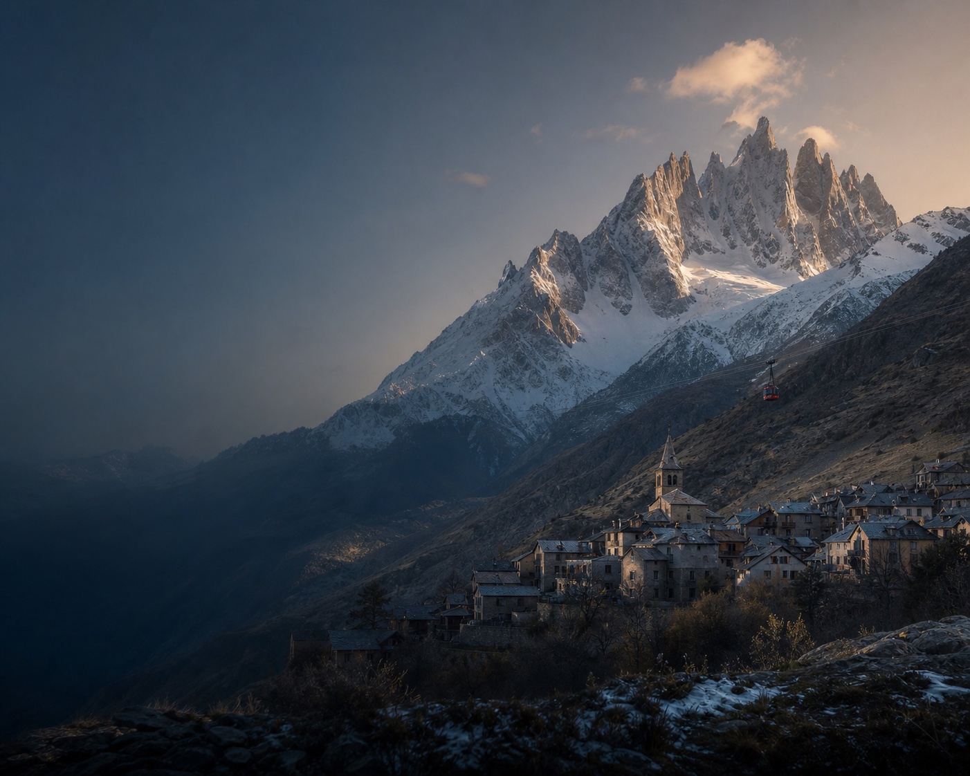 La Grave's stone village and red cable car beneath the jagged La Meije massif