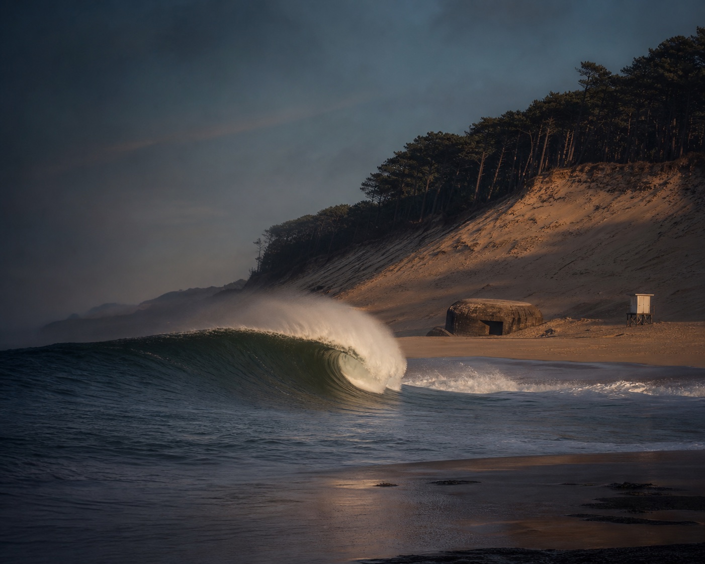 A heavy La Gravière barrel breaking beside Hossegor's dunes
