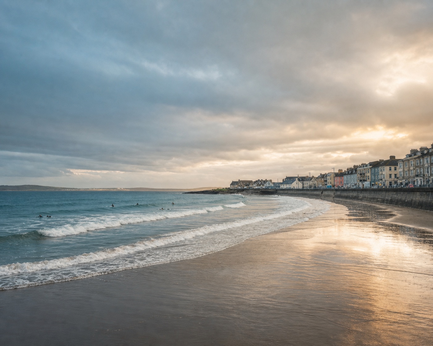 Surf and wet sand curving beneath Lahinch's seafront promenade