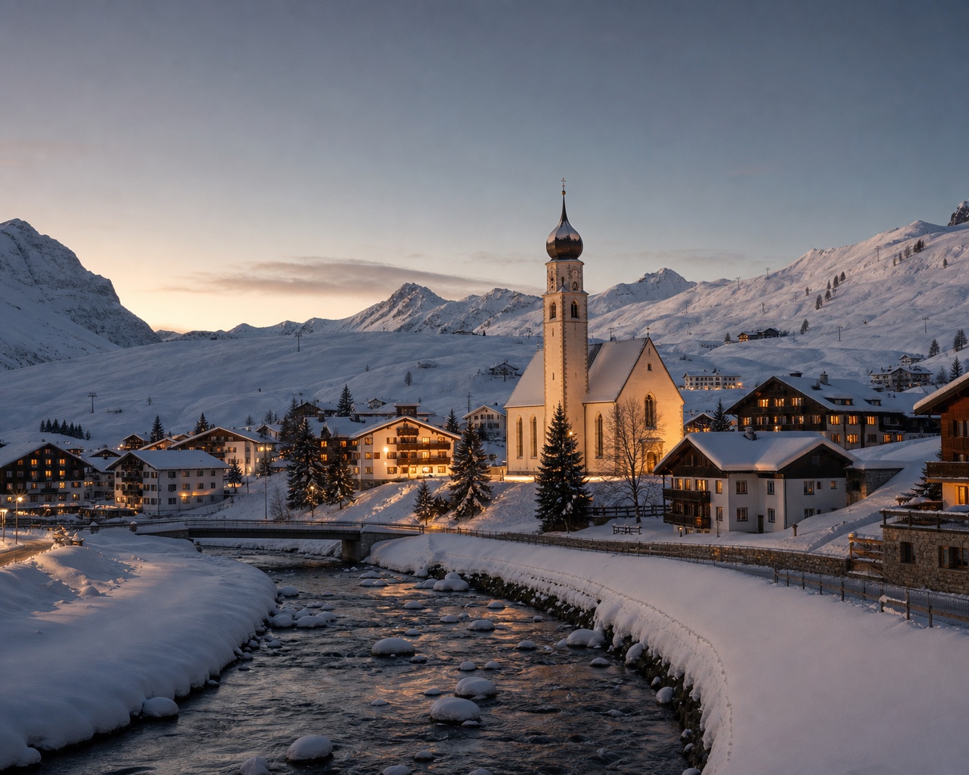 St Nicholas church beside the river and snow-covered village of Lech