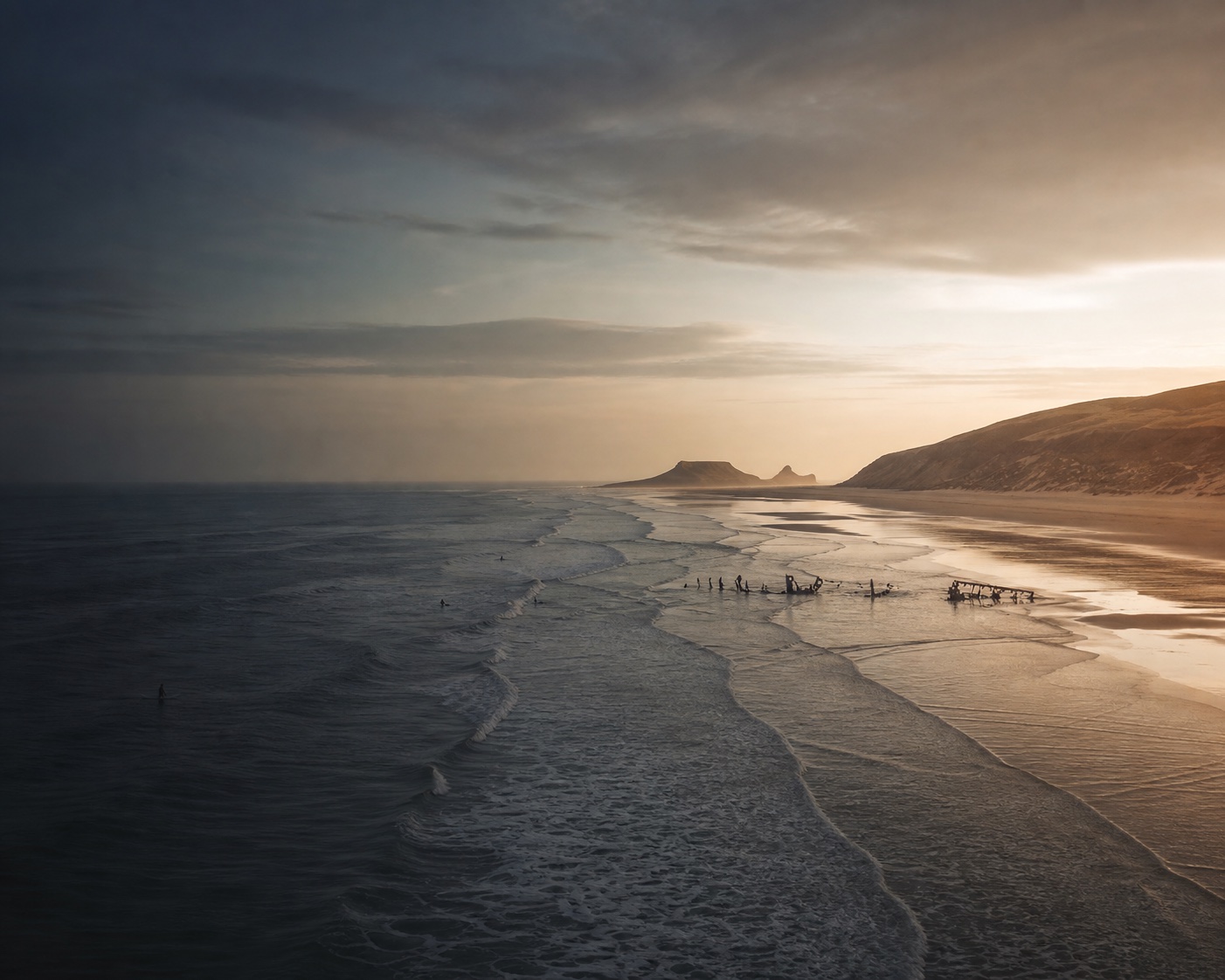 Llangennith surf sweeping along Rhossili Bay towards Worm's Head