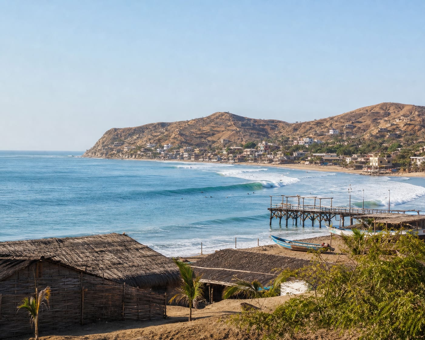Máncora surf and fishing pier beneath the dry hills of northern Peru