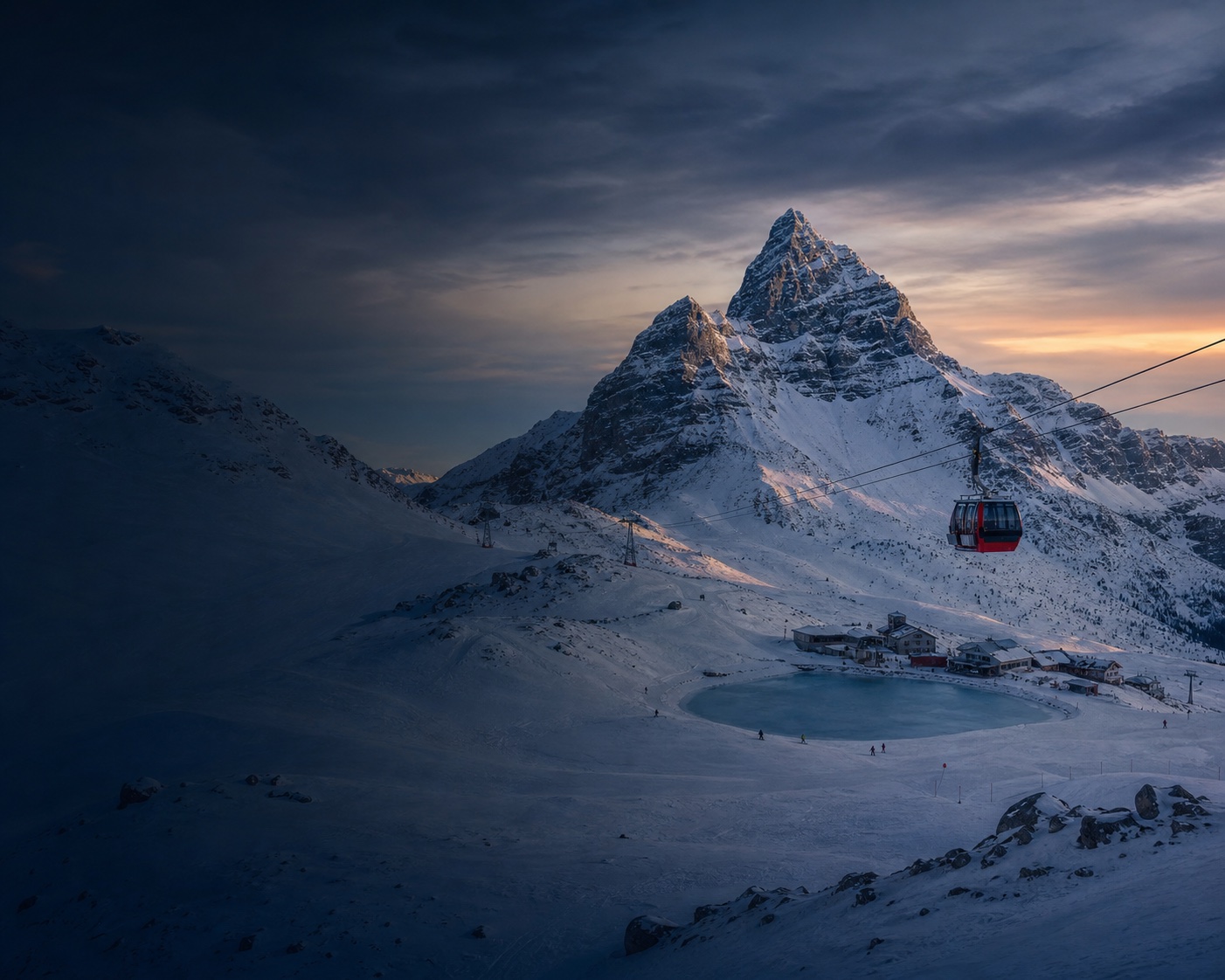 A red gondola crossing Nassfeld's snowy pass beneath the Gartnerkofel