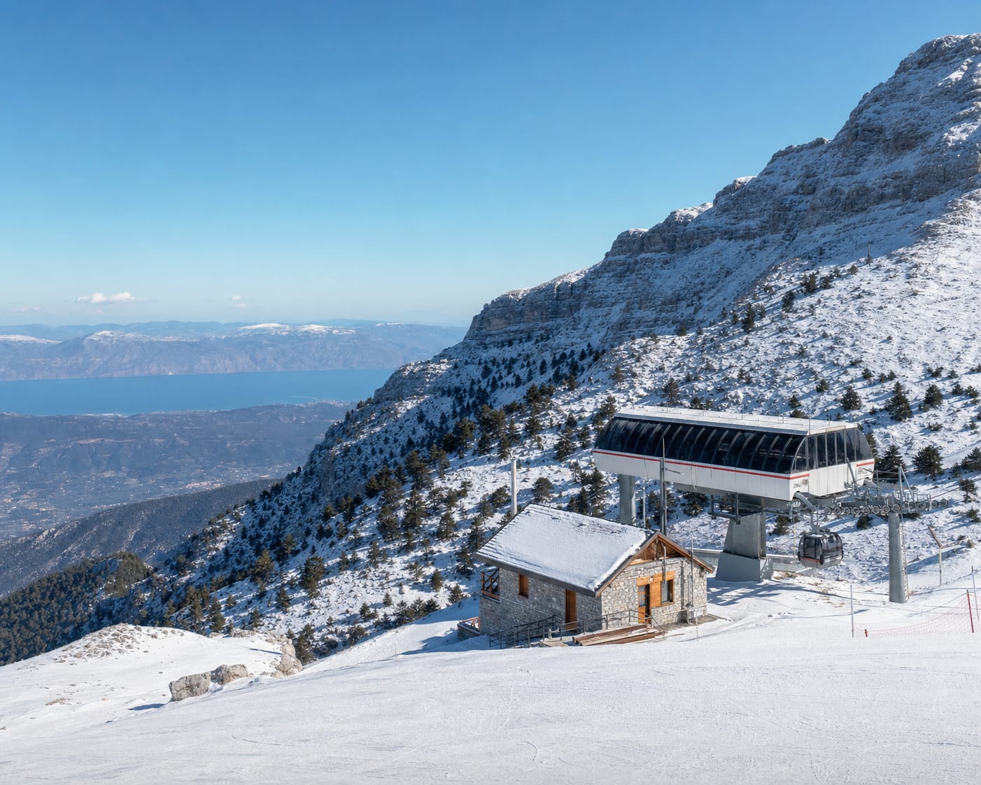 Parnassos lift and mountain chalet above distant Mediterranean waters