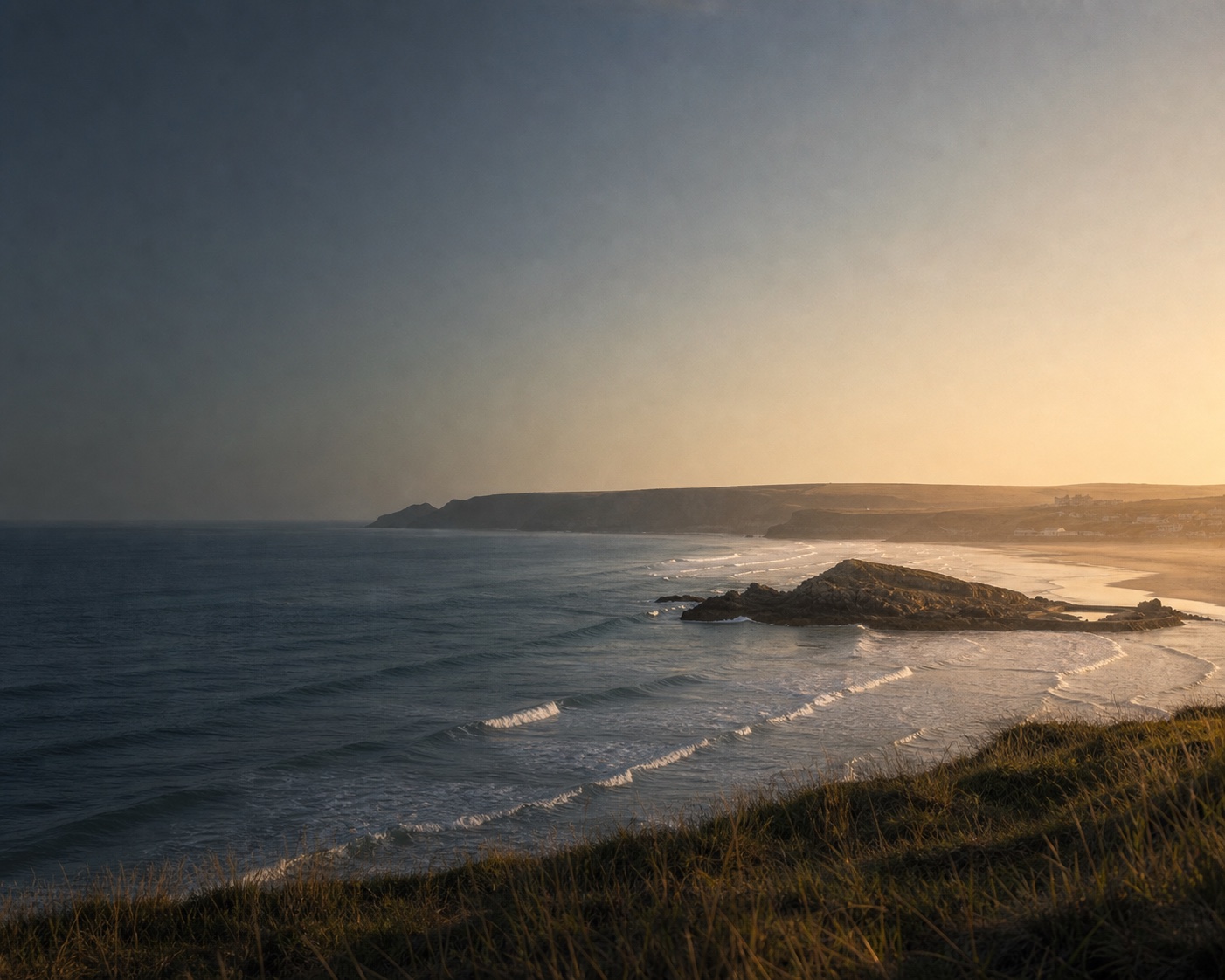 Atlantic surf wrapping around Chapel Rock on Perranporth's long beach