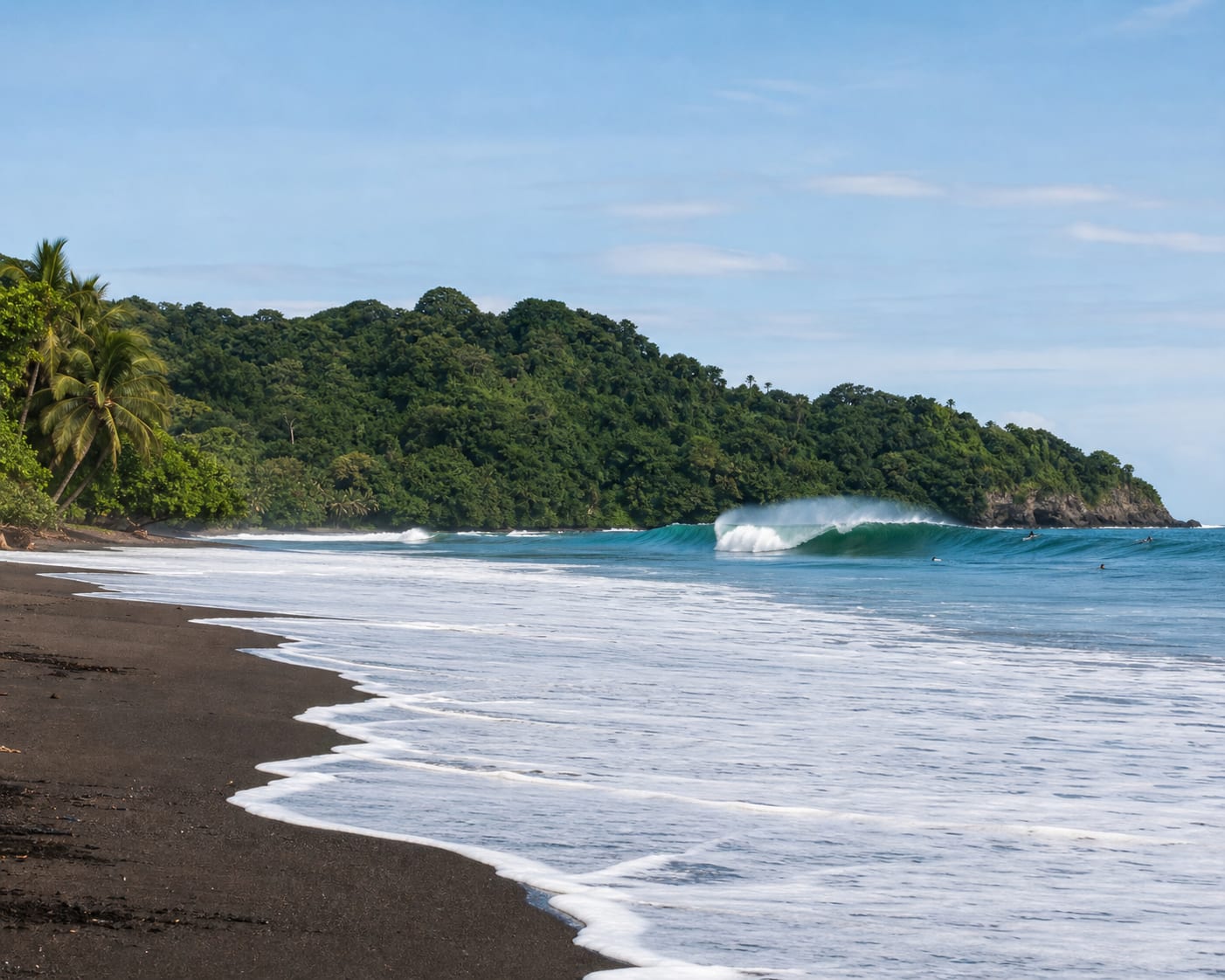 Playa Hermosa surf breaking along a black-sand Costa Rican beach
