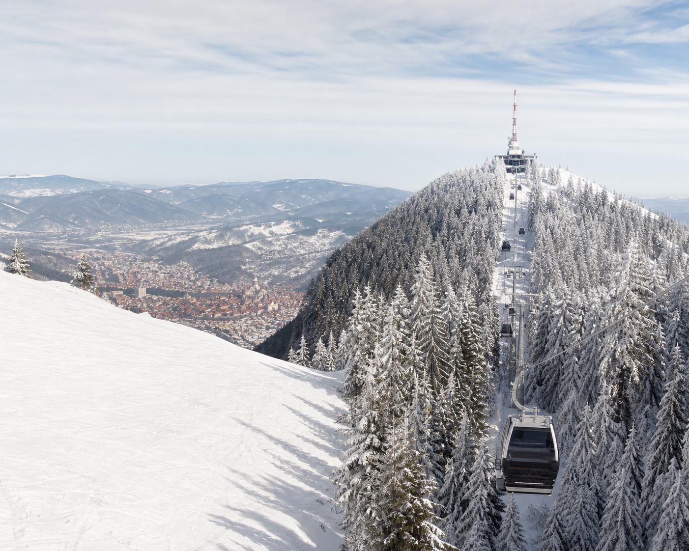 Poiana Brașov gondola climbing snowy Postăvaru above Brașov