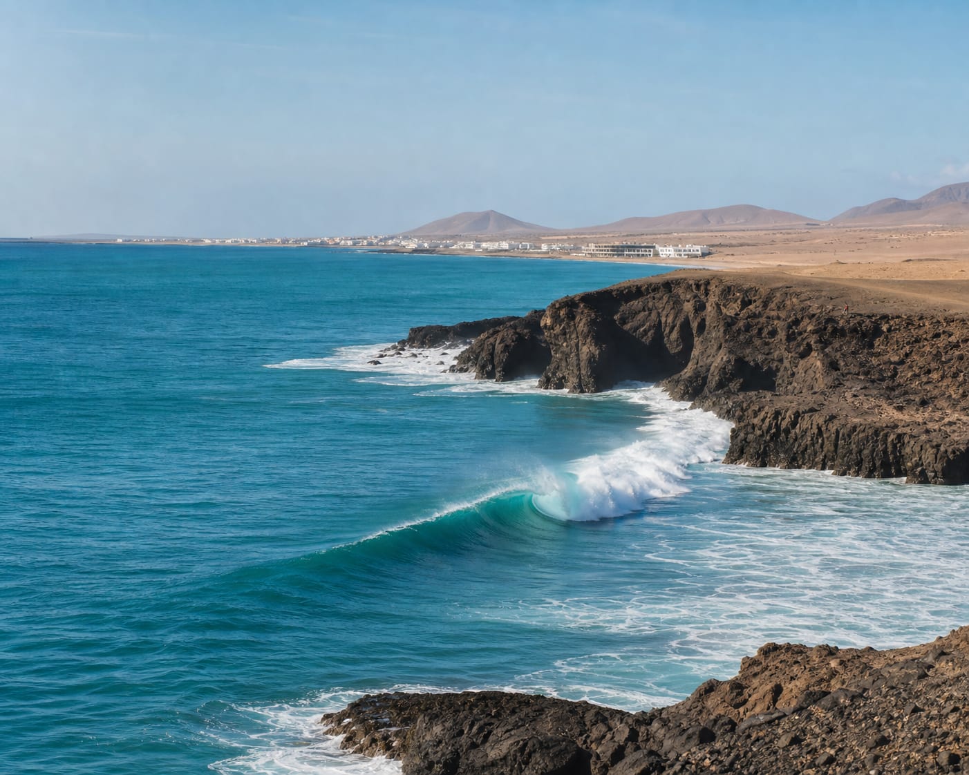Ponta Preta surf wrapping around Sal's arid black volcanic headland