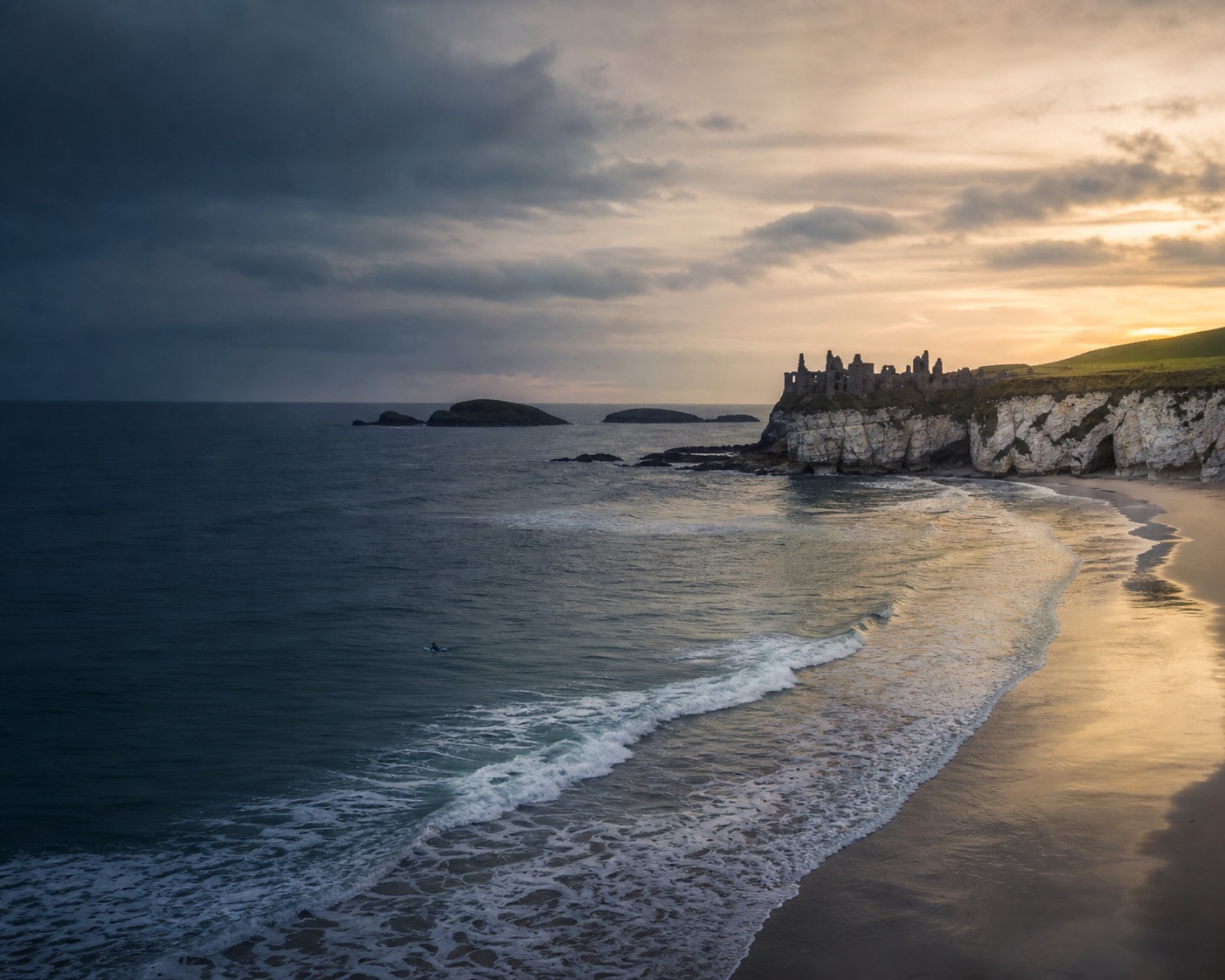 Portrush surf and white limestone cliffs beneath Dunluce Castle