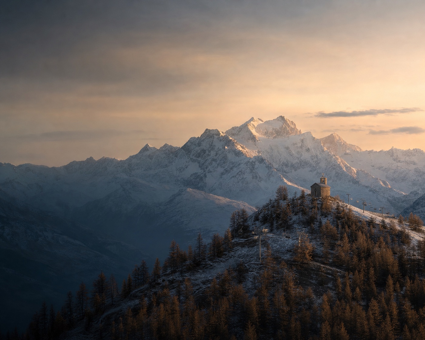 Chapelle Saint-Romain above Puy-Saint-Vincent's larch slopes and Écrins peaks