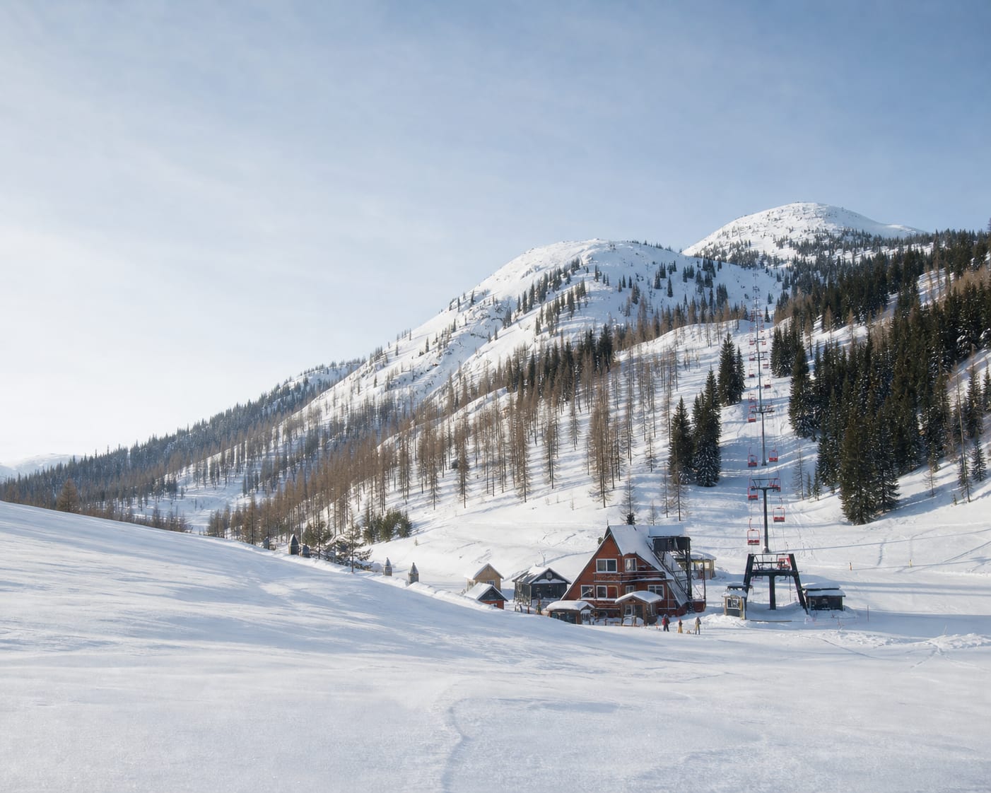 RED Mountain chairlift and compact base beneath the rounded Kootenay peaks