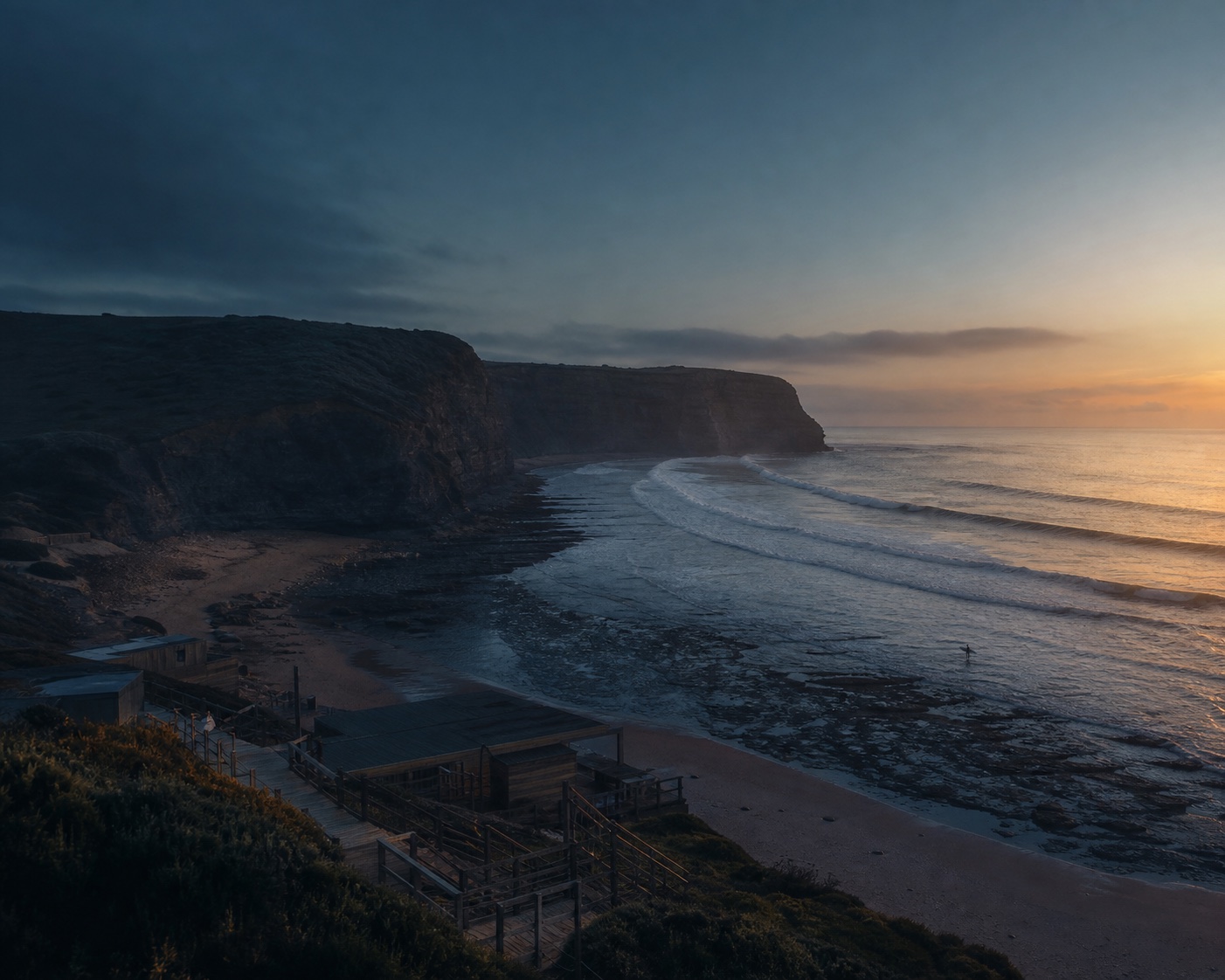 Long reef waves peeling into Ribeira d'Ilhas' cliff-lined bay