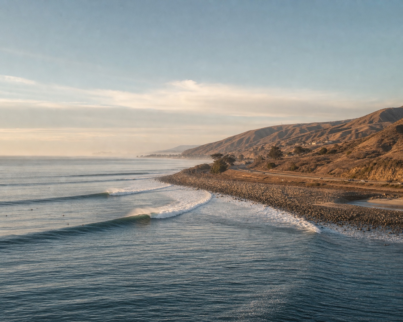 Long right-breaking waves wrapping around Rincon's cobblestone point