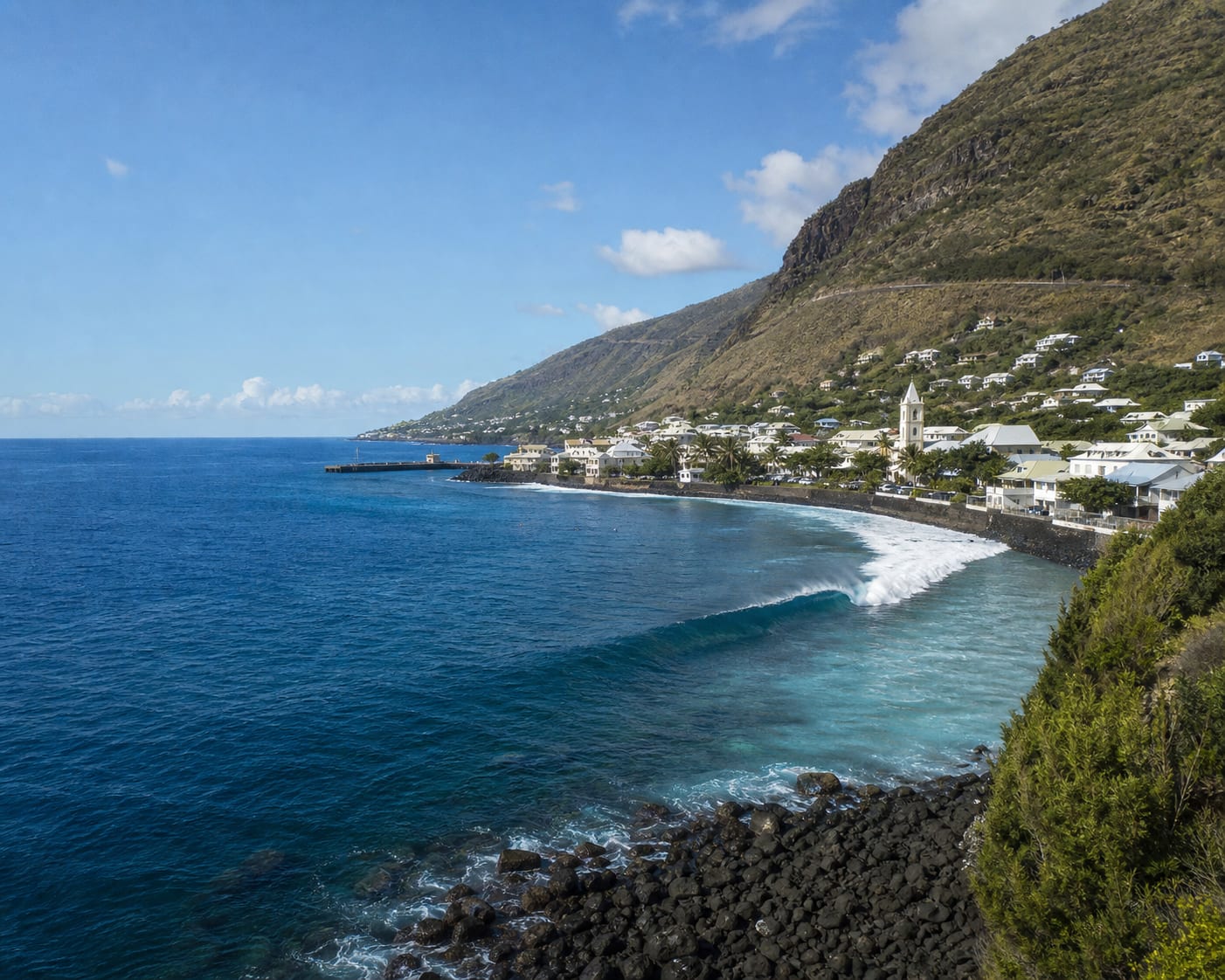 Saint-Leu reef surf beneath the steep volcanic slopes of Réunion
